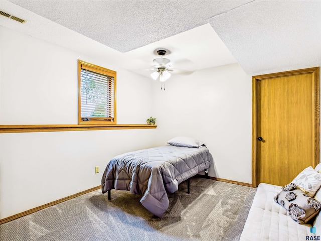 26481 487th Ave, Valley Springs, SD 57068 - carpeted bedroom featuring a textured ceiling and baseboards