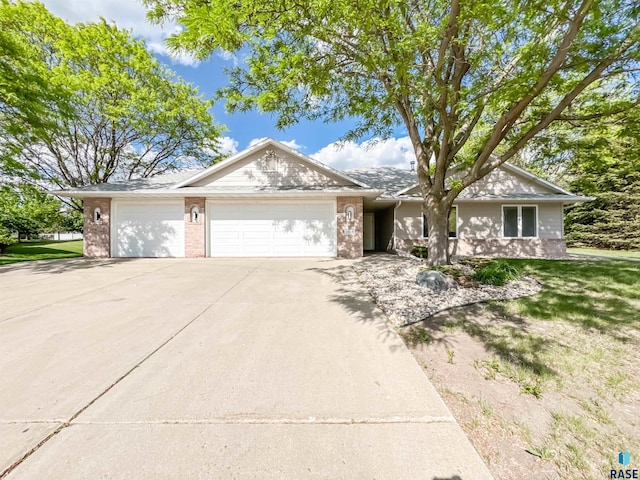 1708 E Ash Grove Cir, Sioux Falls, SD 57108 - ranch-style house with a garage, driveway, and brick siding