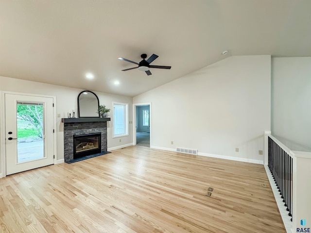 1708 E Ash Grove Cir, Sioux Falls, SD 57108 - unfurnished living room with a ceiling fan, a stone fireplace, vaulted ceiling, and light wood-style flooring