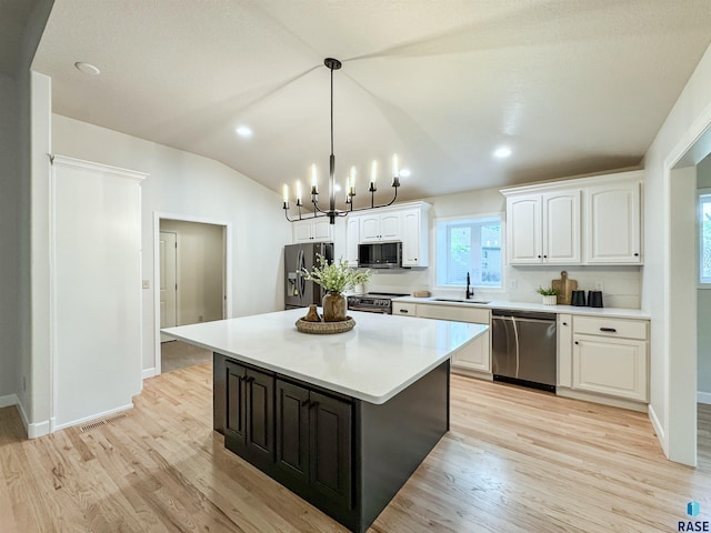 1708 E Ash Grove Cir, Sioux Falls, SD 57108 - kitchen featuring appliances with stainless steel finishes, white cabinets, light wood-style floors, light countertops, and a chandelier