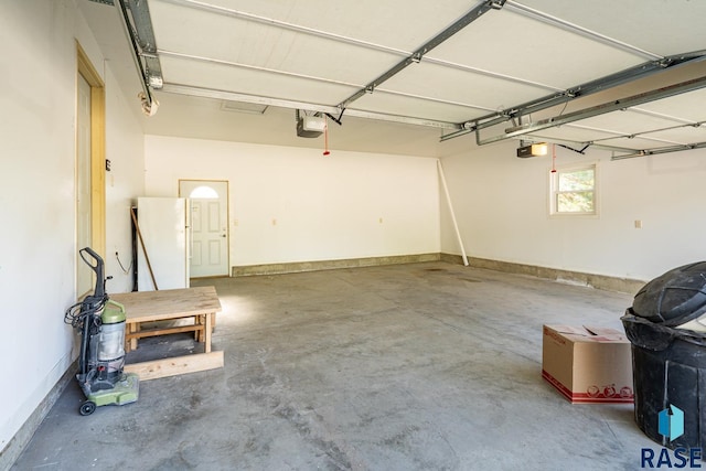 108 S Sycamore Ave, Sioux Falls, SD 57110 - garage featuring a garage door opener and freestanding refrigerator