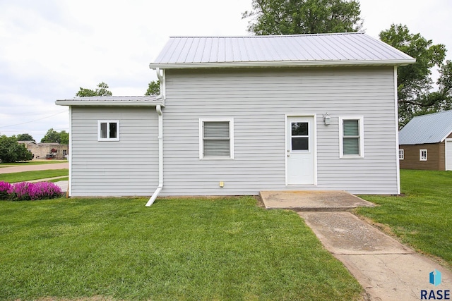 129 S Main Ave, Colman, SD 57017 - rear view of property with a yard and a metal roof