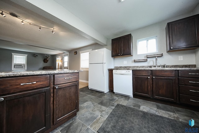 129 S Main Ave, Colman, SD 57017 - kitchen featuring white appliances, healthy amount of natural light, dark brown cabinetry, and dark stone finish flooring