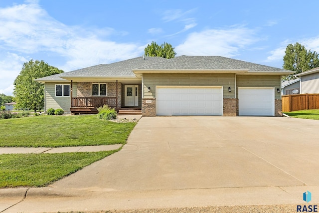 908 W 4th Ave, Lennox, SD 57039 - view of front of property with concrete driveway, an attached garage, brick siding, and roof with shingles
