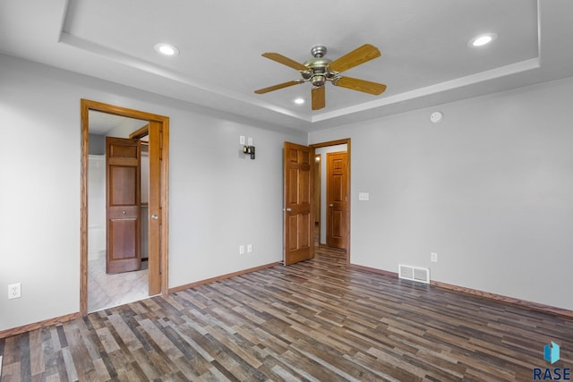 908 W 4th Ave, Lennox, SD 57039 - empty room with a tray ceiling, wood finished floors, a ceiling fan, and recessed lighting