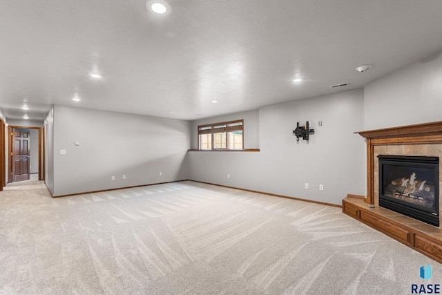 908 W 4th Ave, Lennox, SD 57039 - unfurnished living room featuring recessed lighting, light carpet, and a fireplace