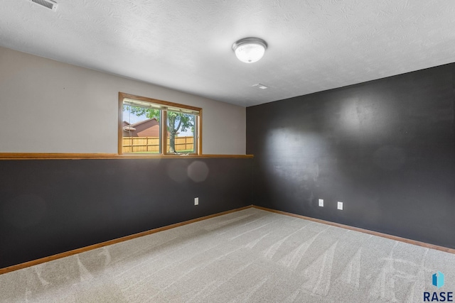 908 W 4th Ave, Lennox, SD 57039 - unfurnished room with carpet floors and a textured ceiling