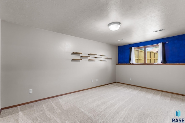 908 W 4th Ave, Lennox, SD 57039 - unfurnished room featuring light colored carpet and a textured ceiling