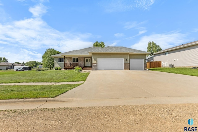 908 W 4th Ave, Lennox, SD 57039 - ranch-style house featuring concrete driveway, an attached garage, brick siding, and covered porch