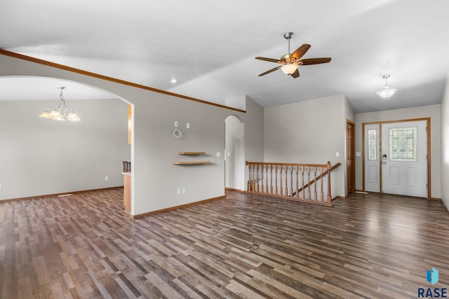 908 W 4th Ave, Lennox, SD 57039 - unfurnished living room featuring arched walkways, a ceiling fan, vaulted ceiling, and wood finished floors