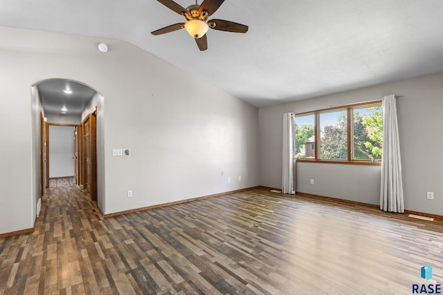 908 W 4th Ave, Lennox, SD 57039 - empty room featuring wood finished floors, arched walkways, a ceiling fan, lofted ceiling, and a smoke detector