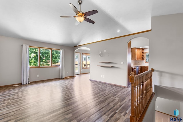 908 W 4th Ave, Lennox, SD 57039 - unfurnished living room featuring arched walkways, wood finished floors, a ceiling fan, lofted ceiling, and recessed lighting