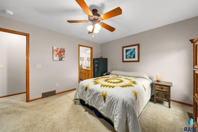 1905 S Wheatland Ct, Sioux Falls, SD 57106 - bedroom with light carpet, ceiling fan, and ensuite bathroom
