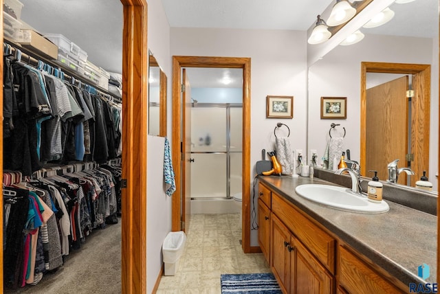 1905 S Wheatland Ct, Sioux Falls, SD 57106 - bathroom with vanity, a stall shower, and a walk in closet