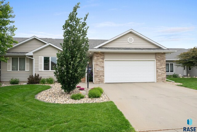 1905 S Wheatland Ct, Sioux Falls, SD 57106 - ranch-style home with brick siding, a garage, concrete driveway, a front lawn, and a shingled roof
