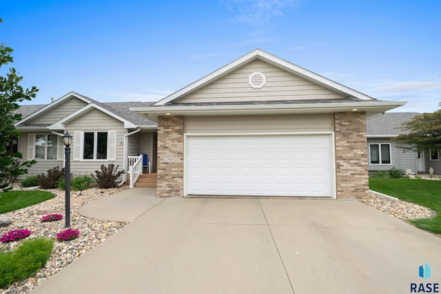 1905 S Wheatland Ct, Sioux Falls, SD 57106 - single story home featuring brick siding, concrete driveway, an attached garage, and a shingled roof