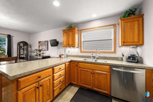 1905 S Wheatland Ct, Sioux Falls, SD 57106 - kitchen with stainless steel dishwasher, a peninsula, brown cabinetry, light tile patterned flooring, and recessed lighting