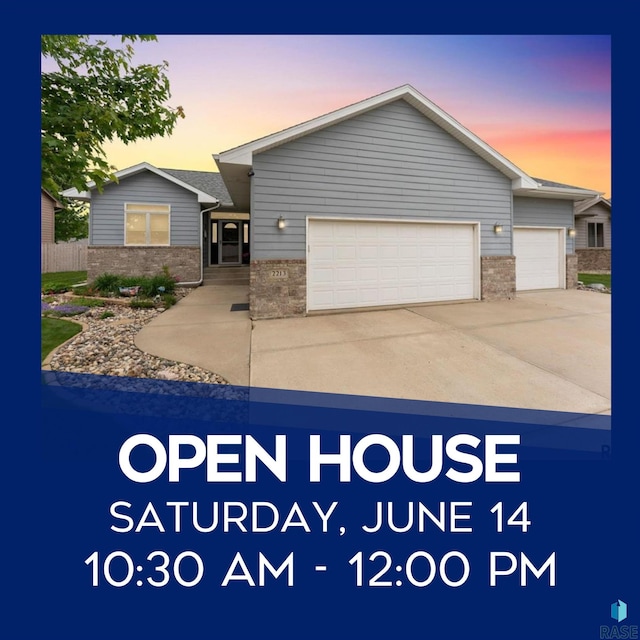 2213 S Purdue Ave, Sioux Falls, SD 57106 - view of front of house with brick siding, a garage, and concrete driveway
