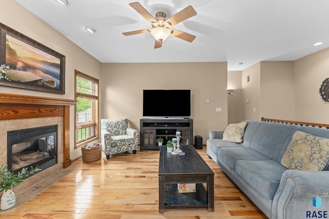 2213 S Purdue Ave, Sioux Falls, SD 57106 - living area featuring light wood-type flooring, a ceiling fan, a tiled fireplace, and recessed lighting