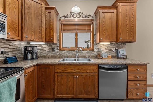 2213 S Purdue Ave, Sioux Falls, SD 57106 - kitchen featuring appliances with stainless steel finishes, decorative backsplash, and brown cabinets