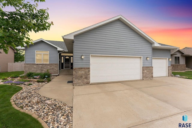 2213 S Purdue Ave, Sioux Falls, SD 57106 - view of front of property with an attached garage, brick siding, and concrete driveway