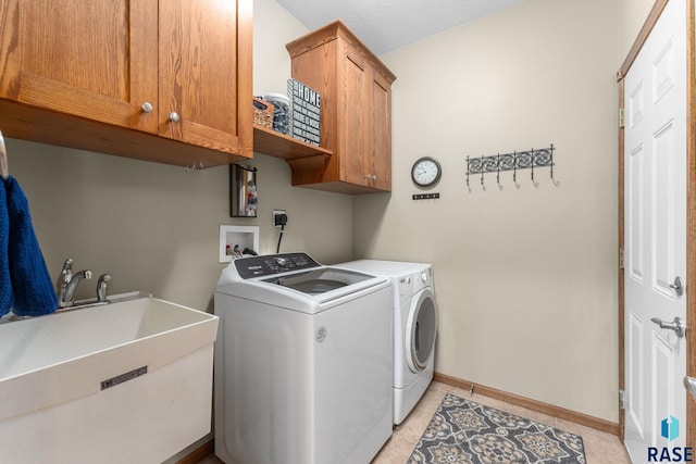 2213 S Purdue Ave, Sioux Falls, SD 57106 - laundry room with washer and clothes dryer, cabinet space, and light tile patterned floors