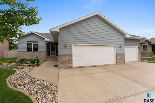 2213 S Purdue Ave, Sioux Falls, SD 57106 - ranch-style home with a garage, brick siding, and concrete driveway