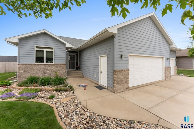 2213 S Purdue Ave, Sioux Falls, SD 57106 - ranch-style house with a garage, driveway, and brick siding