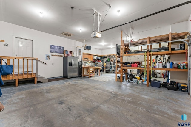 2213 S Purdue Ave, Sioux Falls, SD 57106 - garage with stainless steel fridge with ice dispenser, a garage door opener, and a workshop area