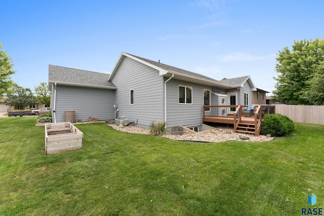 2213 S Purdue Ave, Sioux Falls, SD 57106 - rear view of house with a deck, a shingled roof, and a garden