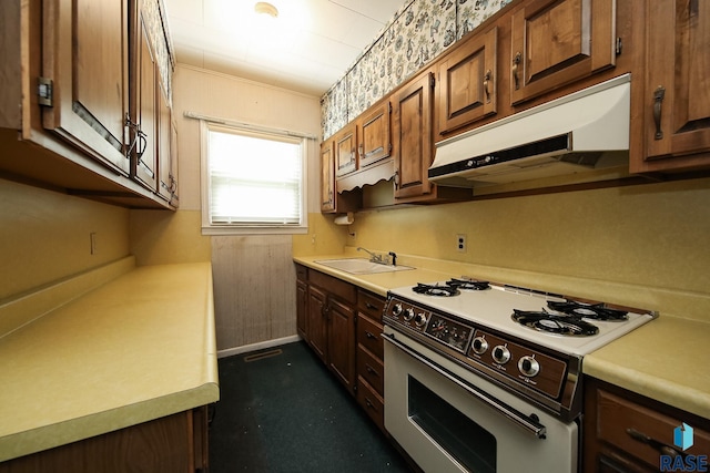 228 N Broadway St, Canton, SD 57013 - kitchen featuring white range with gas stovetop, under cabinet range hood, and light countertops