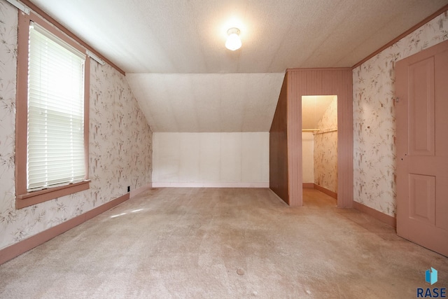228 N Broadway St, Canton, SD 57013 - additional living space with carpet, wallpapered walls, and vaulted ceiling