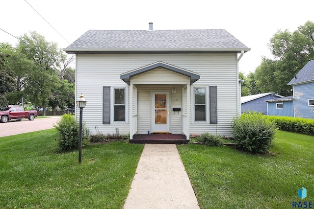 228 N Broadway St, Canton, SD 57013 - view of front facade with a front lawn and roof with shingles