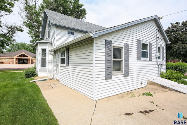 228 N Broadway St, Canton, SD 57013 - view of side of home with roof with shingles and a yard