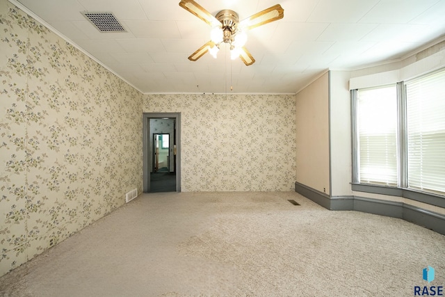 228 N Broadway St, Canton, SD 57013 - spare room featuring a ceiling fan, carpet floors, ornamental molding, and wallpapered walls