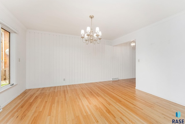 915 E Ridge Rd, Sioux Falls, SD 57105 - spare room featuring wood-type flooring, a chandelier, and ornamental molding