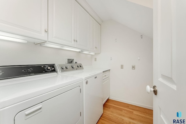 915 E Ridge Rd, Sioux Falls, SD 57105 - laundry area with washer and clothes dryer, light wood-style floors, and cabinet space