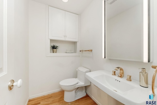 915 E Ridge Rd, Sioux Falls, SD 57105 - bathroom featuring toilet and wood finished floors