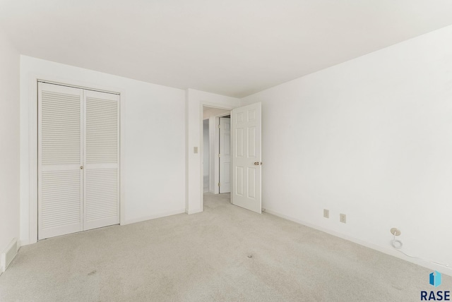 915 E Ridge Rd, Sioux Falls, SD 57105 - unfurnished bedroom featuring light colored carpet and a closet