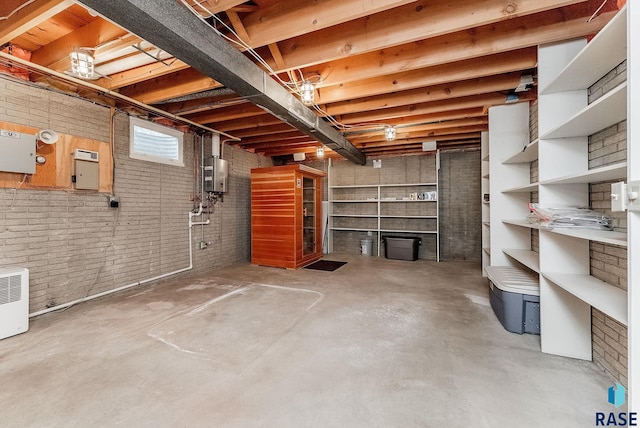 915 E Ridge Rd, Sioux Falls, SD 57105 - basement featuring brick wall and water heater