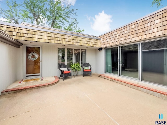 915 E Ridge Rd, Sioux Falls, SD 57105 - property entrance with a patio area and mansard roof