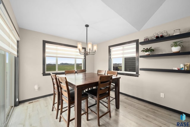 7513 E 49th St, Sioux Falls, SD 57110 - dining space with light wood-type flooring, healthy amount of natural light, a chandelier, and vaulted ceiling