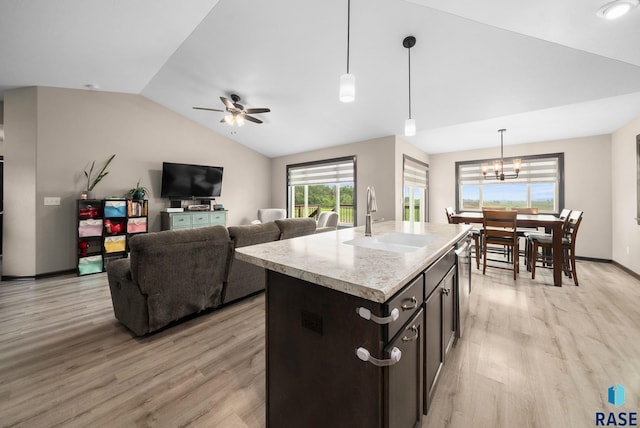 7513 E 49th St, Sioux Falls, SD 57110 - kitchen featuring lofted ceiling, light wood-style flooring, hanging light fixtures, ceiling fan, and a center island with sink