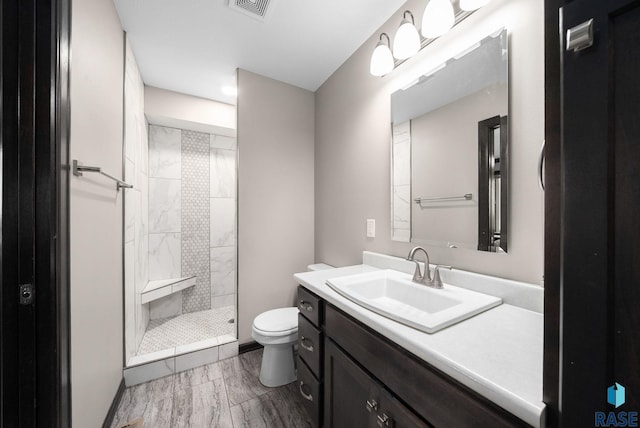 7513 E 49th St, Sioux Falls, SD 57110 - bathroom featuring vanity, a stall shower, and wood finished floors
