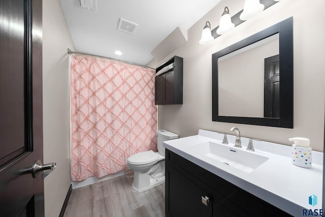 7513 E 49th St, Sioux Falls, SD 57110 - bathroom featuring wood finished floors, vanity, and shower / tub combo