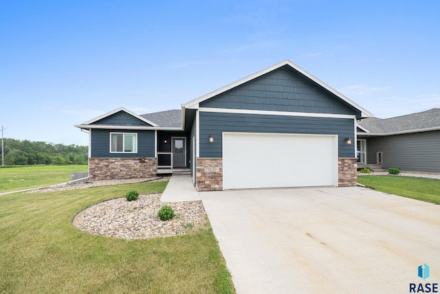 7513 E 49th St, Sioux Falls, SD 57110 - view of front of home with an attached garage, a front lawn, concrete driveway, and stone siding