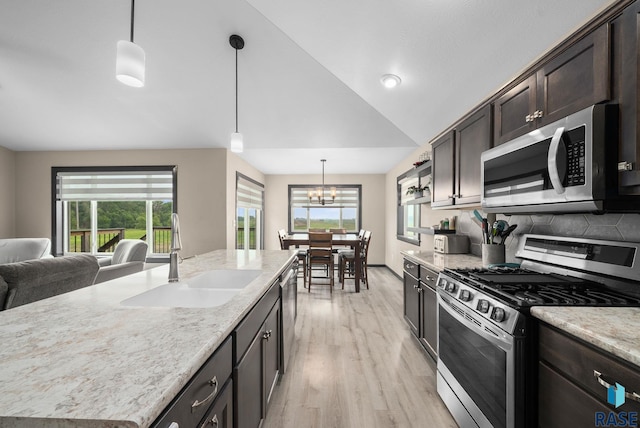 7513 E 49th St, Sioux Falls, SD 57110 - kitchen with appliances with stainless steel finishes, light wood-style flooring, dark brown cabinetry, a chandelier, and lofted ceiling