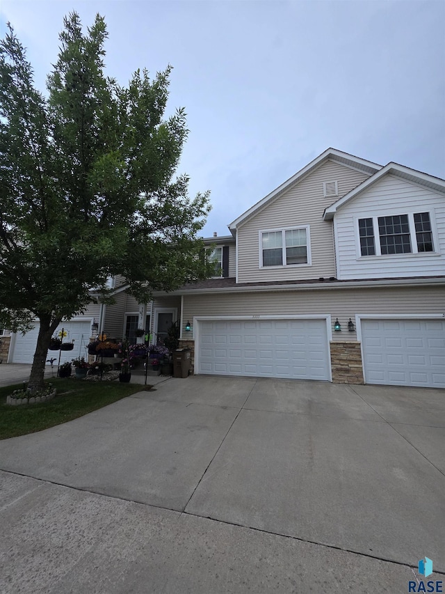 3333 W Ralph Rogers Rd, Sioux Falls, SD 57108 - view of front facade featuring concrete driveway, a garage, and stone siding
