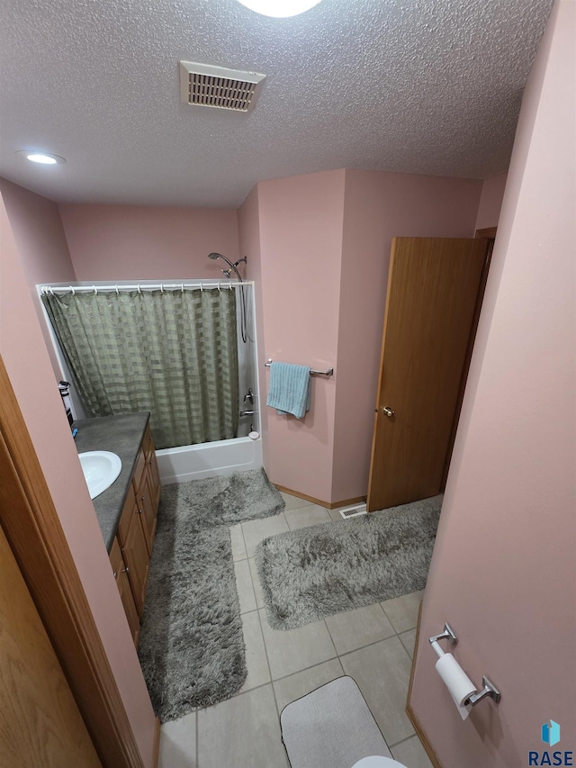 3333 W Ralph Rogers Rd, Sioux Falls, SD 57108 - full bath featuring a textured ceiling, shower / bath combination with curtain, vanity, and tile patterned flooring