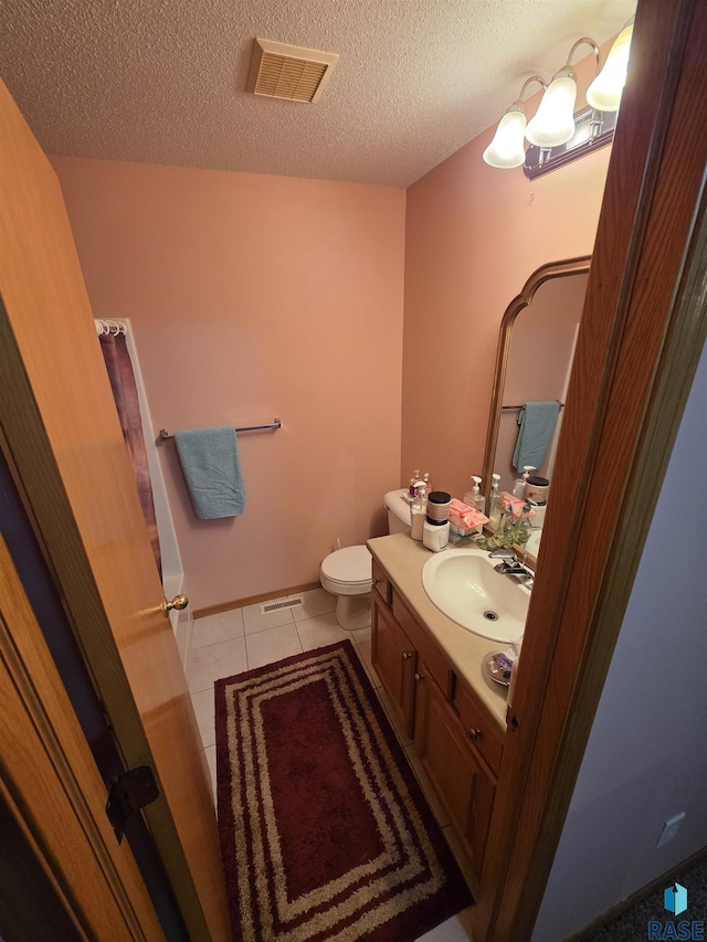 3333 W Ralph Rogers Rd, Sioux Falls, SD 57108 - bathroom featuring vanity, tile patterned floors, and a textured ceiling